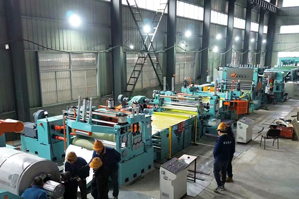 Cut to length line operating in a processing plant with stacked sheets and coil storage.