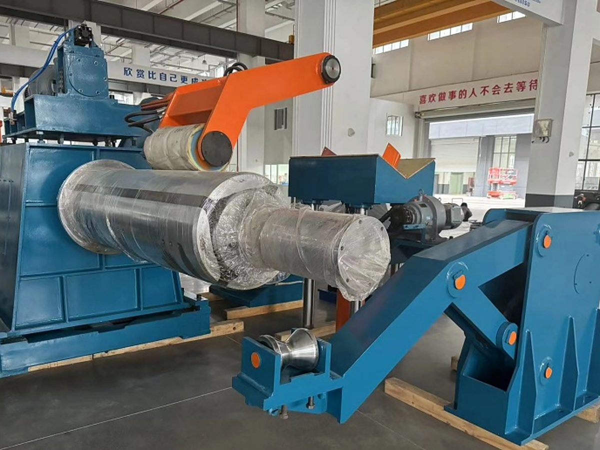 Slitting line recoiler holding a steel coil in a processing workshop.